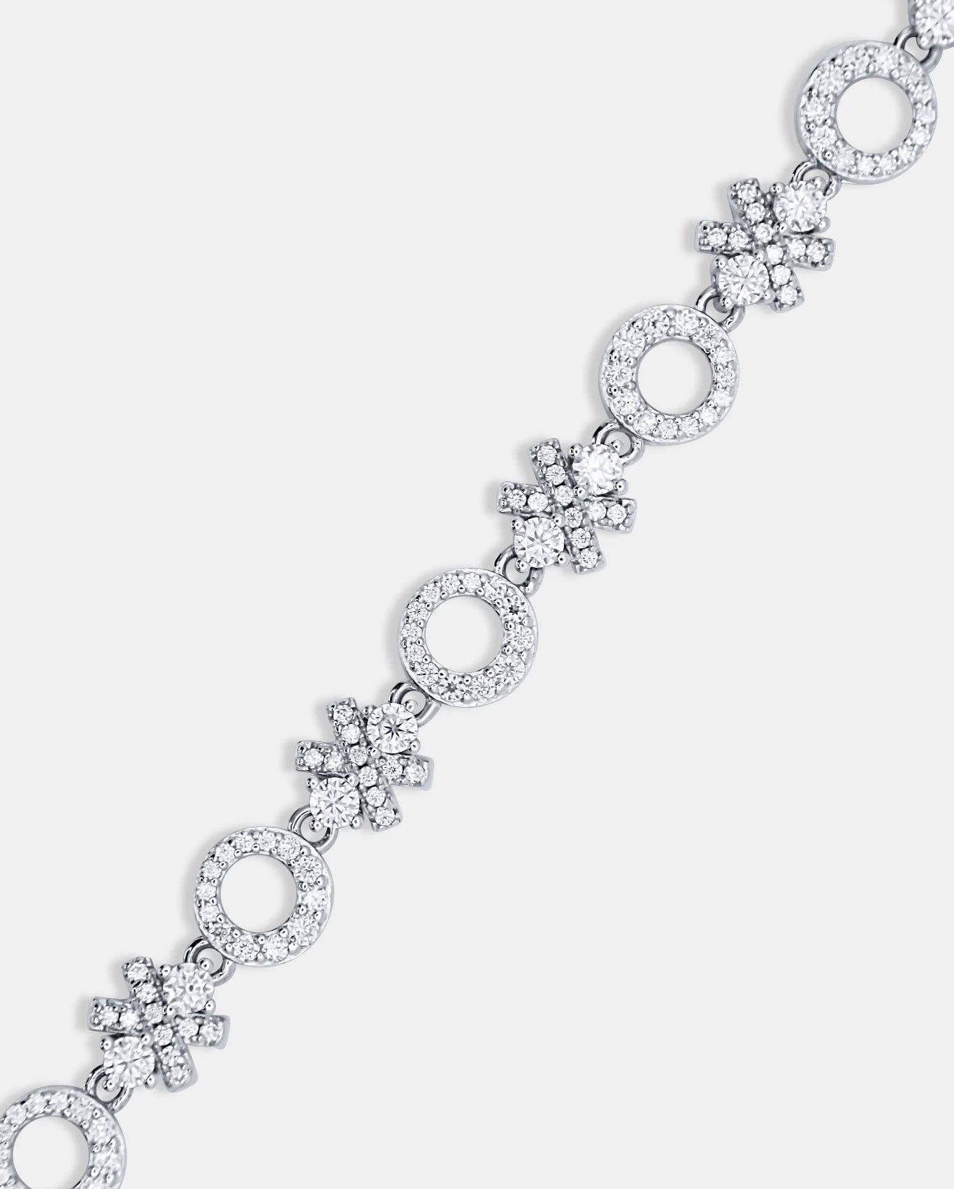Diagonal close-up of the ÉLIX 925 silver bracelet showing alternating pavé moissanite O-shaped and X-shaped links on a white background — AETHER