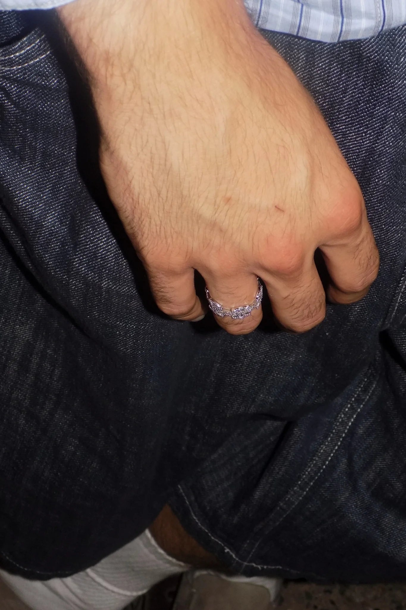 Lifestyle view of the SYMMETRIA 925 silver ring with pavé VVS moissanite stones worn with dark denim — AETHER